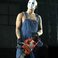 Image 1: Eminem wearing a white mask and carrying a chain saw
