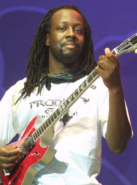 Wyclef Jean performing with guitar
