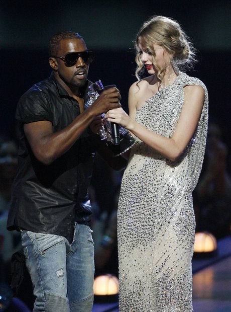 Kanye West takes the microphone from singer Taylor