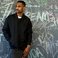 Image 1: Big Sean standing in front of a chalkboard