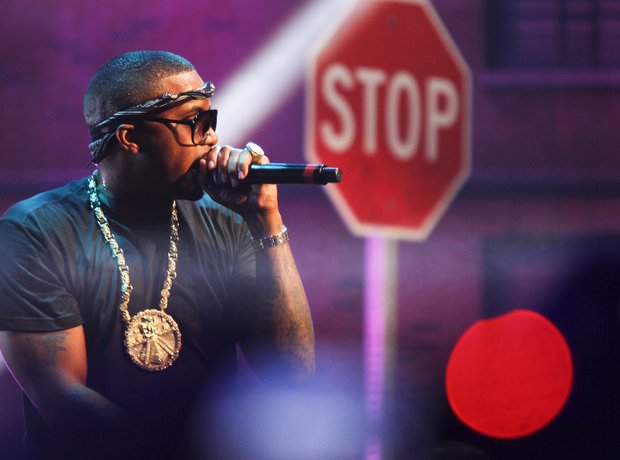 Nas in front of a stop sign