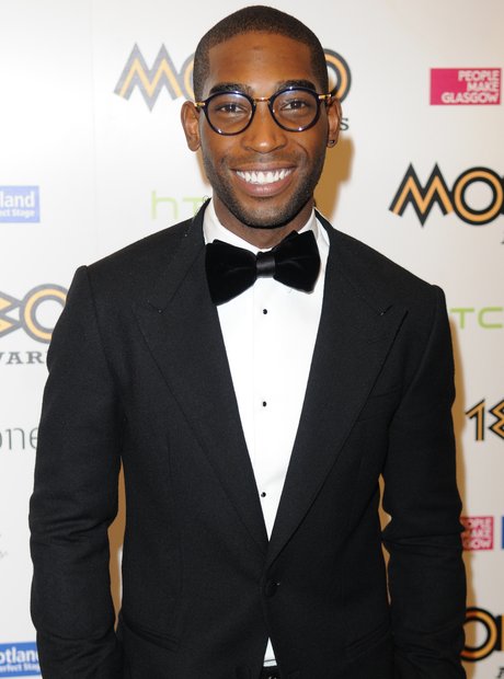 Tinie Tempah wearing suit and smiling at Mobo Awards 2013