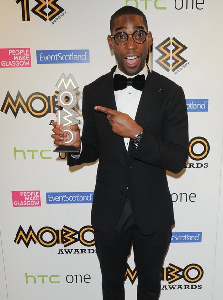 Tinie Tempah holding his Mobo Awards 2013