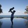 Image 9: Jay Z holding up Blue Ivy Carter next to swimming pool.