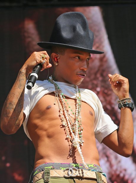 Pharrell Williams live on stage baring chest