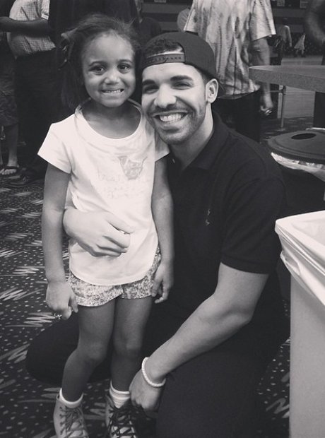 Drake smiling with child