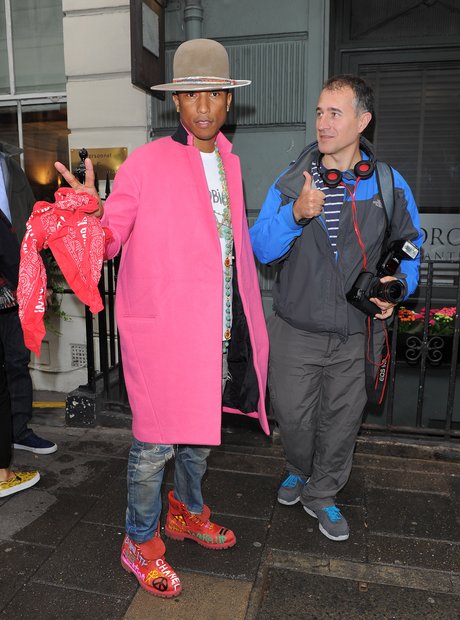 Pharell wearing a pink coat