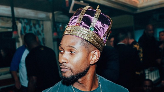 Usher wearing a crown