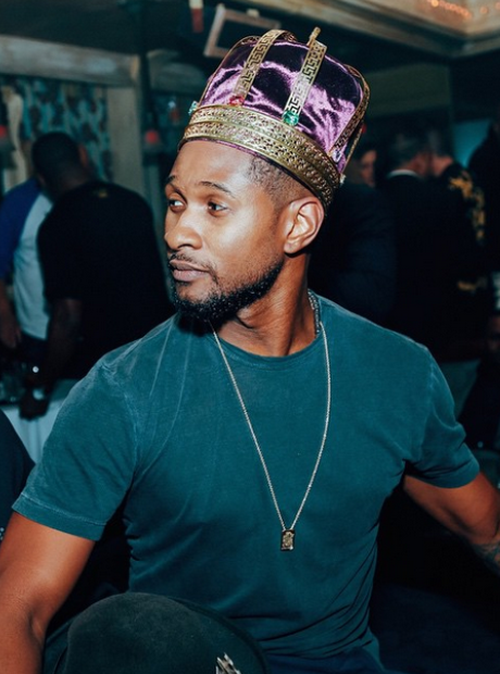 Usher wearing a crown