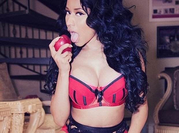 Nicki MInaj biting an apple at Halloween