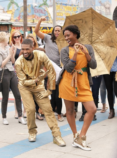 Usher dresses as a gold statue