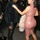 Image 1: Kim Kardashian wearinga rubber dress with Kanye 