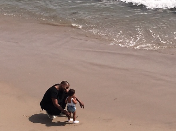 Kanye West with daughter North on the beach