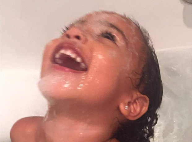 North West in the bath laughing 