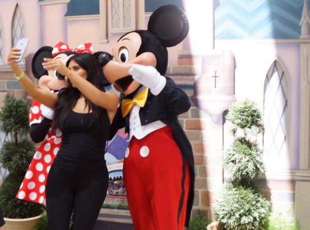 Kim Kardashian taking a selfie with Micky Mouse 