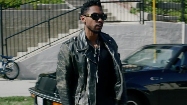 Miguel walking down the street in music video