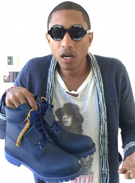Pharrell Williams holding trainers
