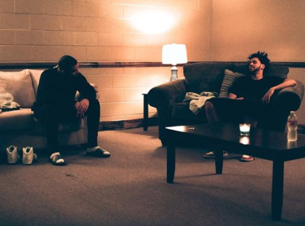 Drake and J. Cole sitting on chairs