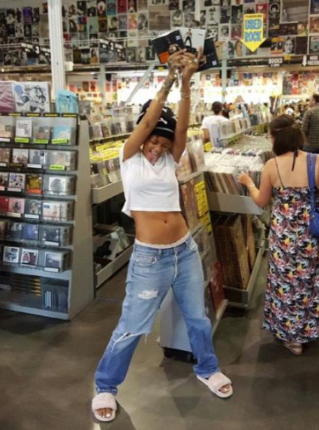 Rihanna with Travis Scott CD in her hand