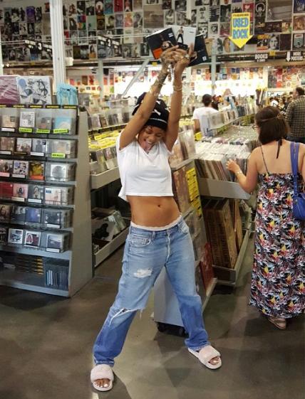 Rihanna with CD in her hand