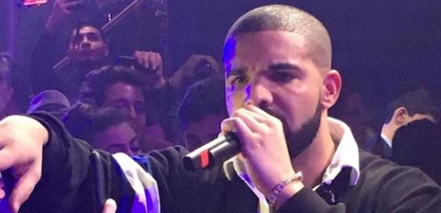 Drake performing with microphone in hand