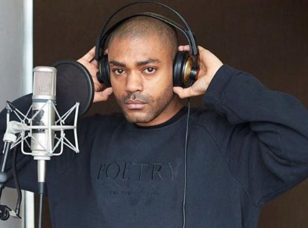 Kano wearing headphones