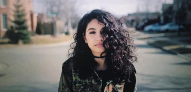 Alessia Cara standing in street