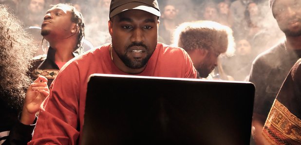 Kanye West looking at computer
