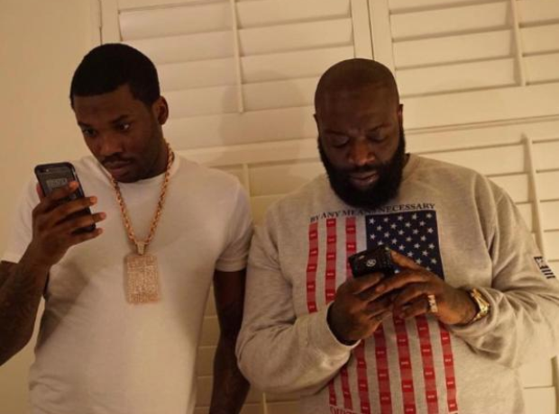 Meek Mill and Rick Ross looking at mobile phones