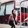 Image 8: Tinashe standing in front of tour bus