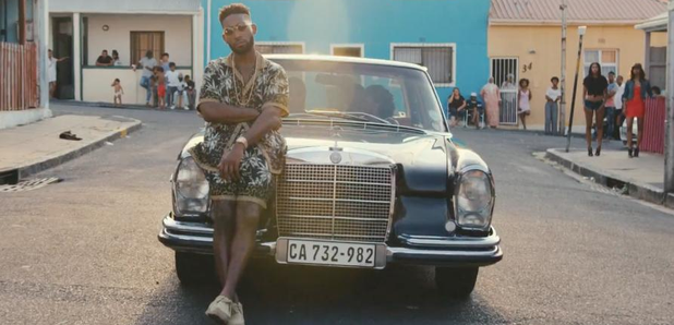 Tinie Tempah stood in front of car