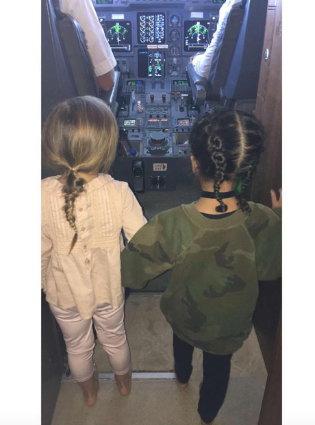 North West and Penelope explore the cockpit of pri
