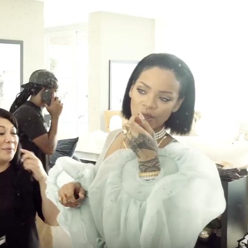Rihanna putting on lip stick