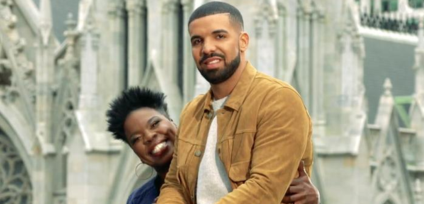 Drake sitting on Leslie Jones' lap.