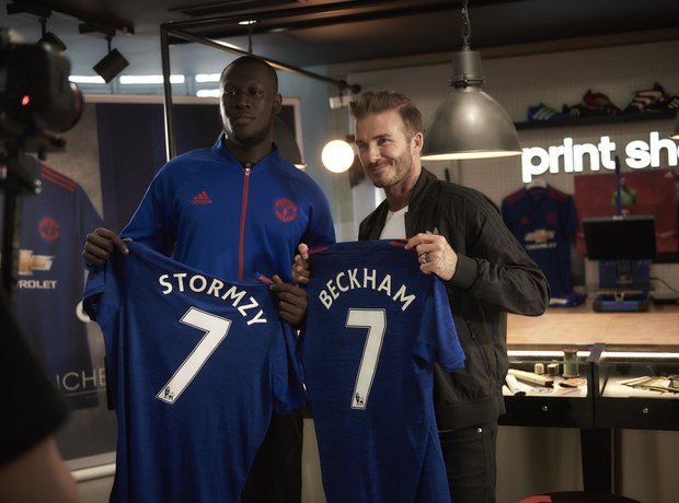 Stormzy and David Beckham holding football shirts