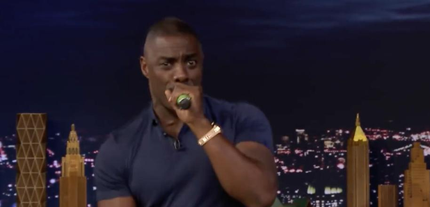 Idris Elba holding microphone