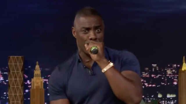 Idris Elba holding microphone