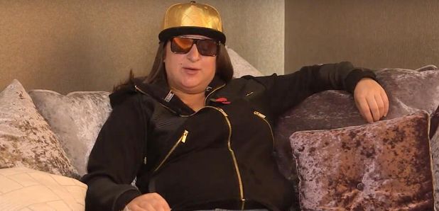 Honey G sitting on sofa