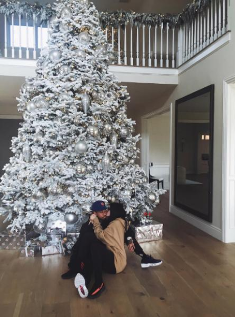 Kylie Jenner and Tyga under a Christmas tree