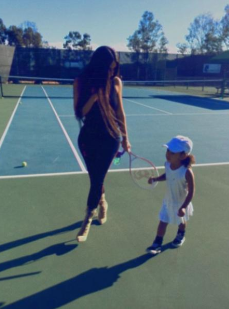 Kim Kardashian and North West playing tennis.