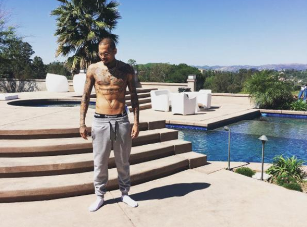 Chris Brown beside his pool