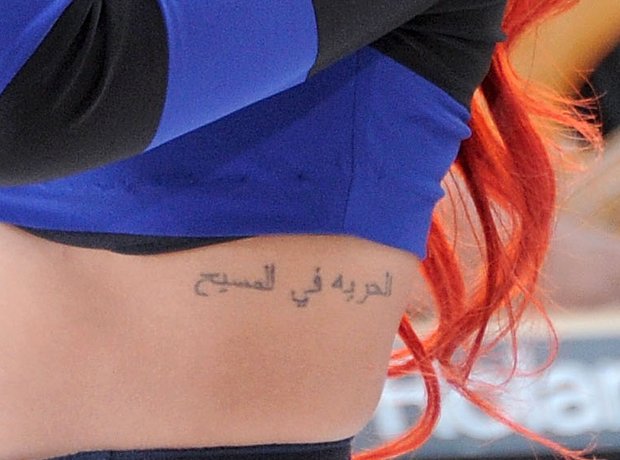 Rihanna Arabic rib tattoo